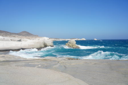 【サラキニコビーチ】打ち寄せる青い波と眩い石灰岩の壁に圧倒される最高の景色！| ミロス島マンドラキア